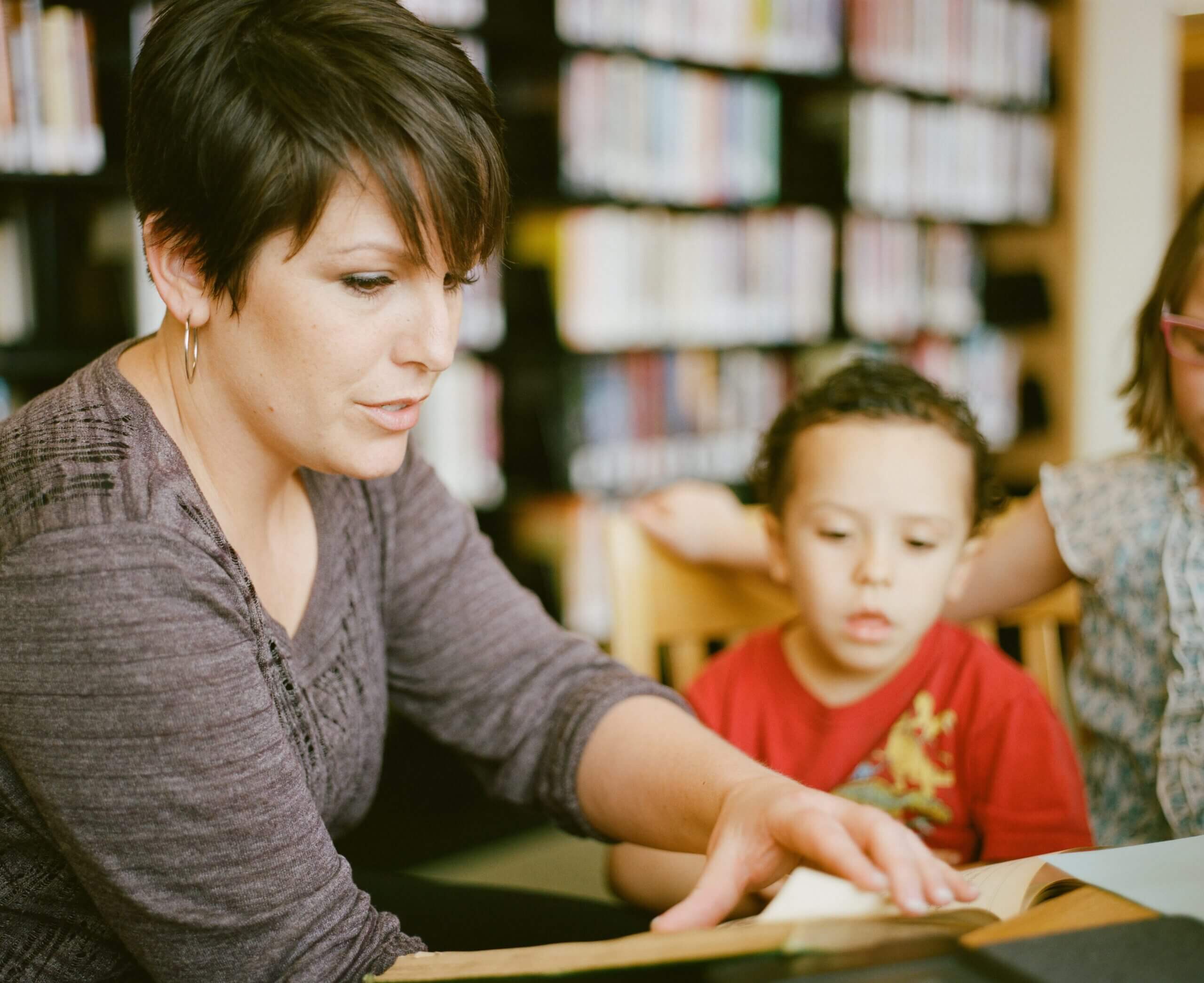 A woman and child reading in the library.